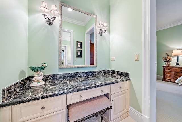 bathroom with vanity with extensive cabinet space and ornamental molding