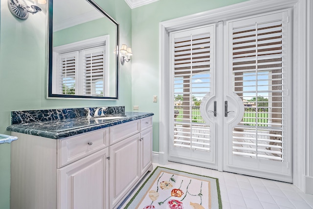 bathroom with ornamental molding, tile floors, and vanity with extensive cabinet space