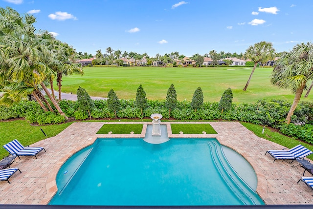 view of pool featuring a lawn and a patio area