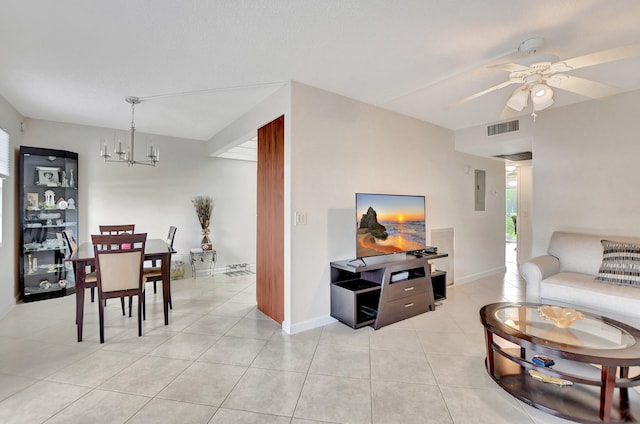 tiled living room with ceiling fan with notable chandelier