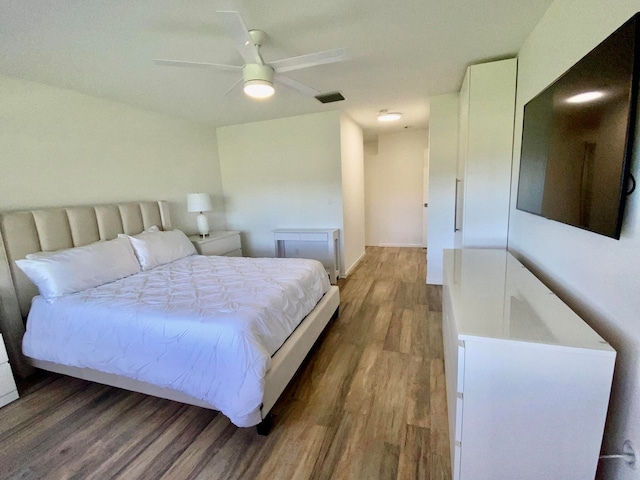 bedroom with wood-type flooring and ceiling fan