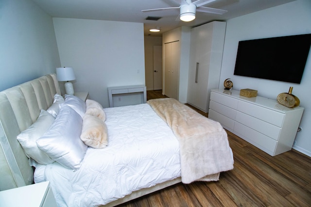 bedroom with a closet, ceiling fan, and dark wood-type flooring