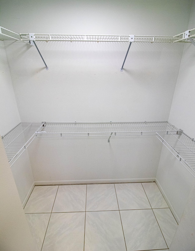 spacious closet featuring light tile flooring