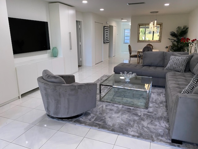 living room with light tile floors and an inviting chandelier