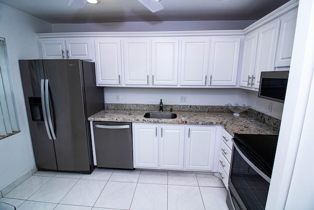 kitchen featuring white cabinetry, light tile flooring, and stainless steel appliances