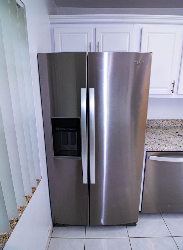 room details with light tile flooring and appliances with stainless steel finishes