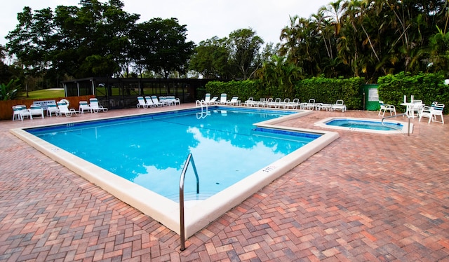 view of swimming pool with a community hot tub and a patio