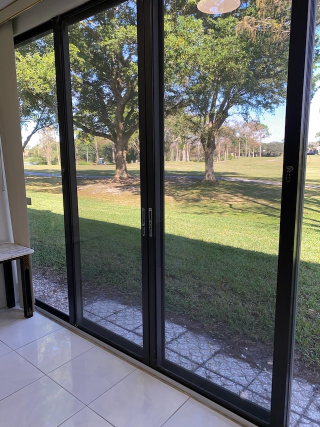 entryway featuring plenty of natural light and light tile flooring