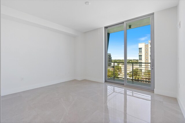 485 E Royal Palm Rd Unit 604, Boca Raton, FL 33432 - empty room featuring floor to ceiling windows and baseboards