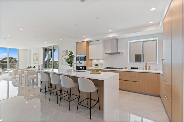485 E Royal Palm Rd Unit 604, Boca Raton, FL 33432 - kitchen featuring a kitchen bar, wall chimney range hood, and modern cabinets
