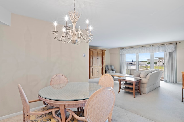 tiled dining room with an inviting chandelier