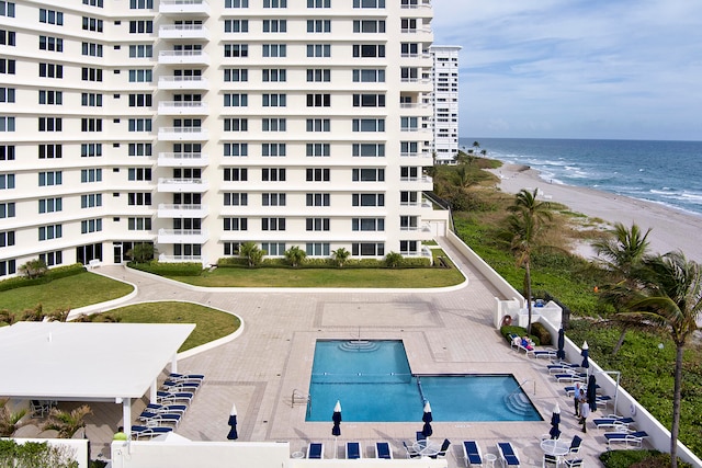 view of property with a water view and a community pool