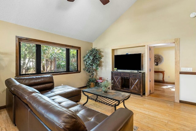 dining area featuring a high ceiling, light hardwood / wood-style floors, and a notable chandelier