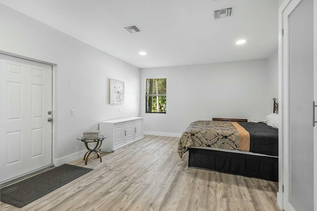 bedroom with ceiling fan, two closets, and light wood-type flooring