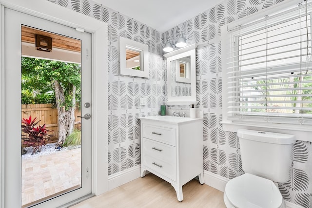 bedroom with light wood-type flooring, a tray ceiling, and a closet