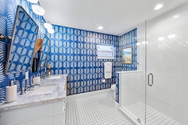 bathroom with tile patterned floors, toilet, an enclosed shower, and vanity