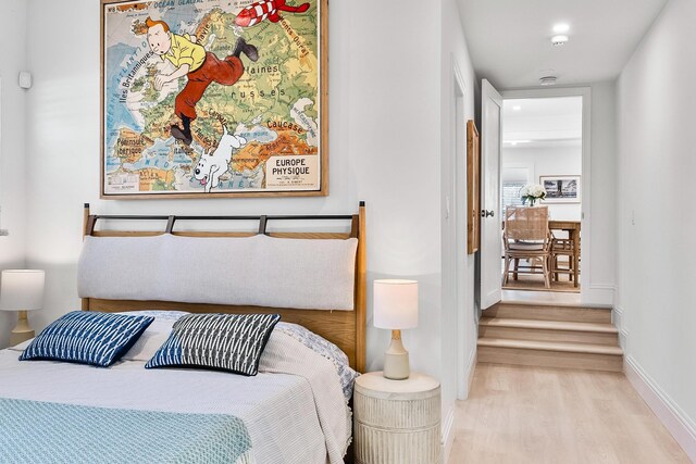 bedroom with a wall unit AC and lofted ceiling with beams