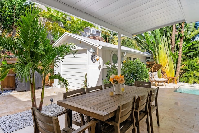 view of patio featuring a shed