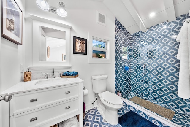 bathroom featuring vanity, toilet, and walk in shower