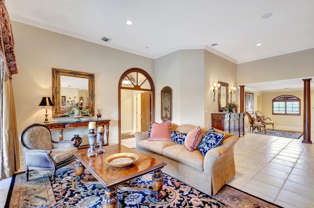 tiled living room with crown molding and ornate columns