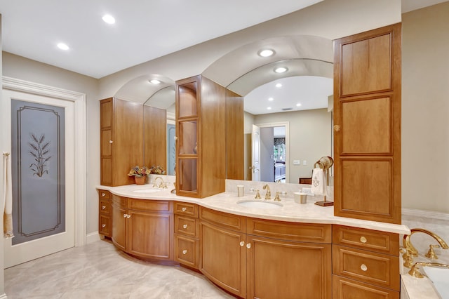 bathroom featuring dual bowl vanity, tile flooring, and walk in shower