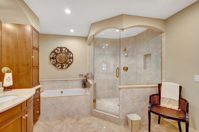 bathroom featuring shower with separate bathtub, tile flooring, and vanity