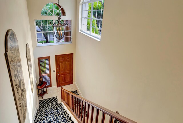 living area featuring crown molding, ornate columns, and light tile flooring