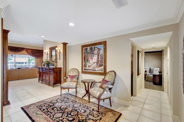 sitting room featuring crown molding, light tile flooring, and ceiling fan