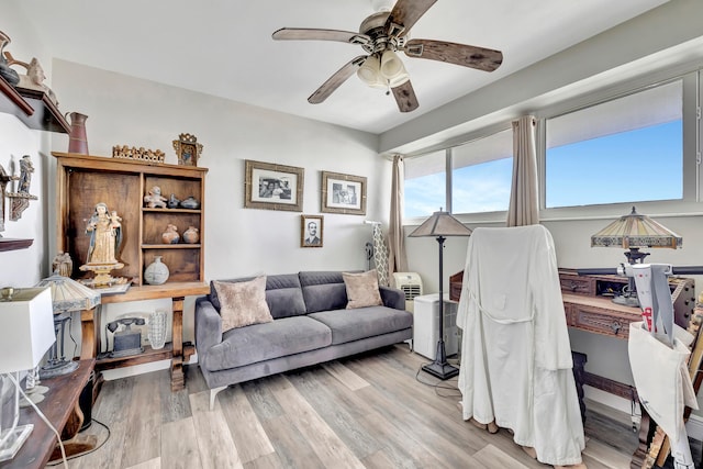 office space with a ceiling fan and light wood-style floors