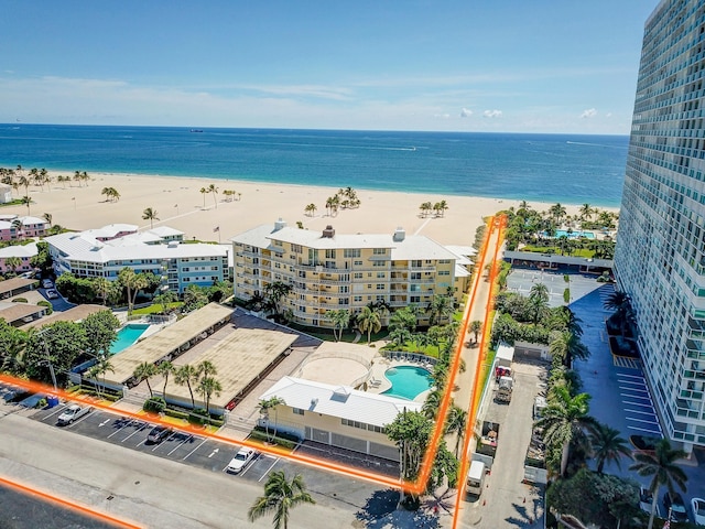 bird's eye view with a water view and a view of the beach