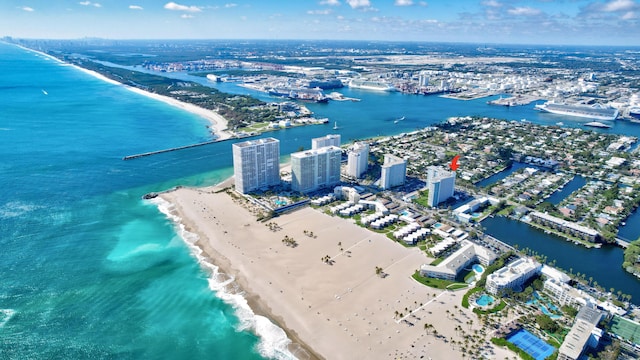 drone / aerial view with a water view, a view of city, and a view of the beach