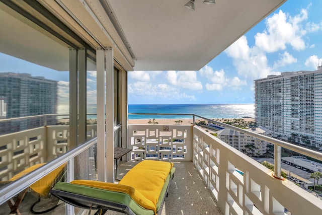 balcony with a water view and a beach view