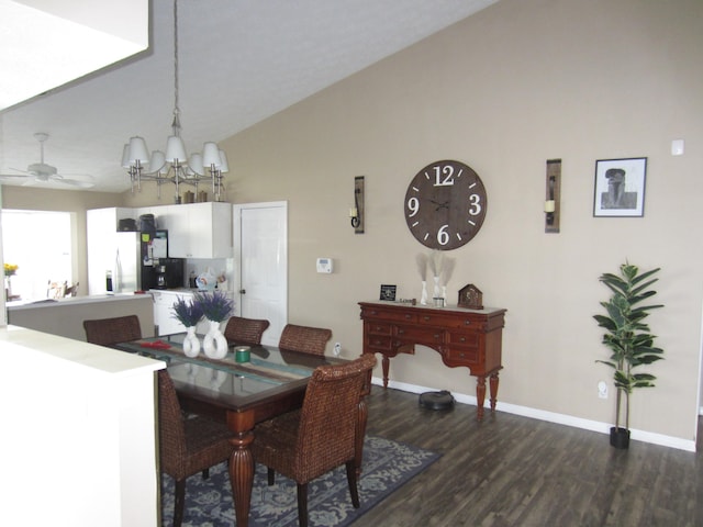 dining space featuring dark hardwood / wood-style floors, ceiling fan with notable chandelier, and lofted ceiling