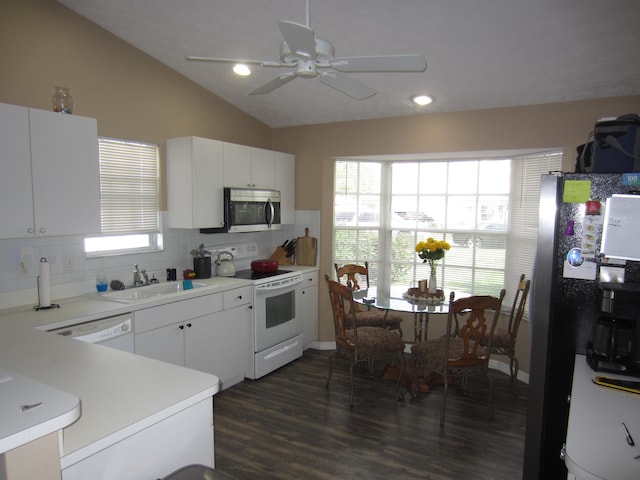 kitchen featuring white cabinets, vaulted ceiling, stainless steel appliances, and sink