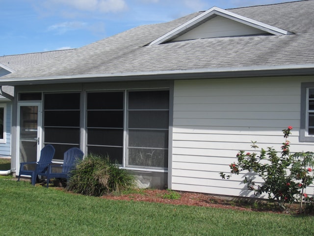 view of side of home featuring a yard