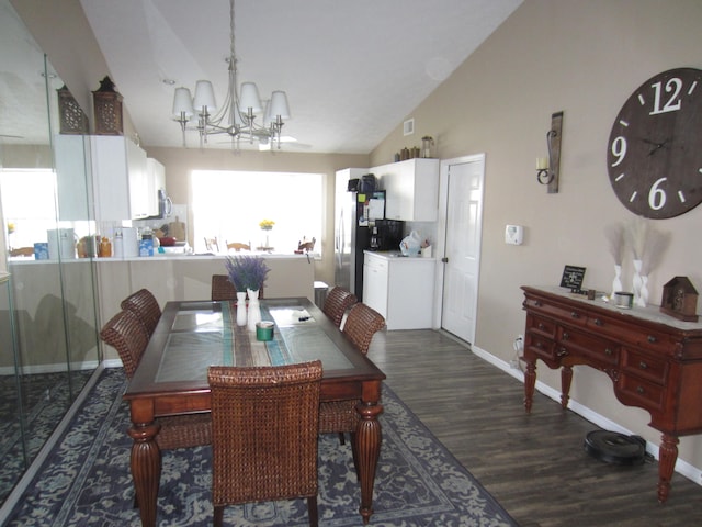 dining area featuring lofted ceiling, dark wood-type flooring, and an inviting chandelier