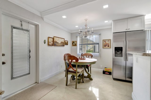 dining room featuring a notable chandelier, crown molding, and light tile flooring