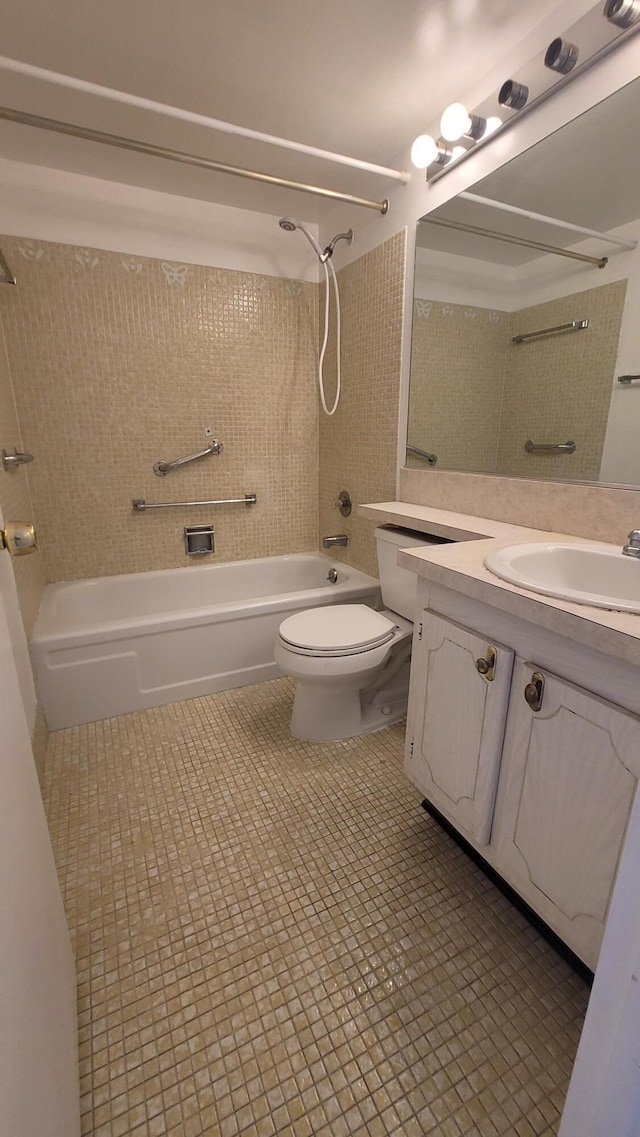 full bathroom featuring tiled shower / bath, toilet, tile floors, and vanity