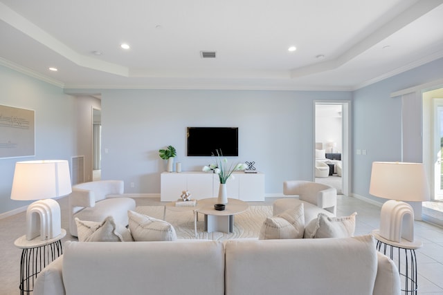 tiled living room featuring a raised ceiling and ornamental molding