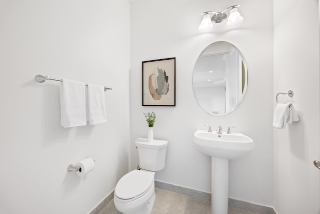 bathroom featuring tile patterned flooring, toilet, and sink