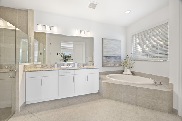 bathroom with tile patterned flooring, vanity, and independent shower and bath