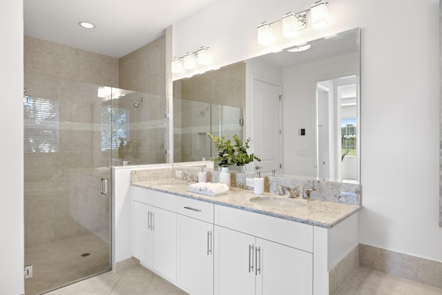 bathroom featuring tile patterned floors, vanity, and walk in shower