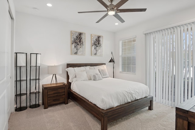 bedroom featuring ceiling fan and light colored carpet