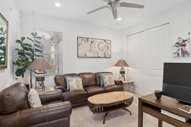 carpeted living room with ceiling fan and a healthy amount of sunlight