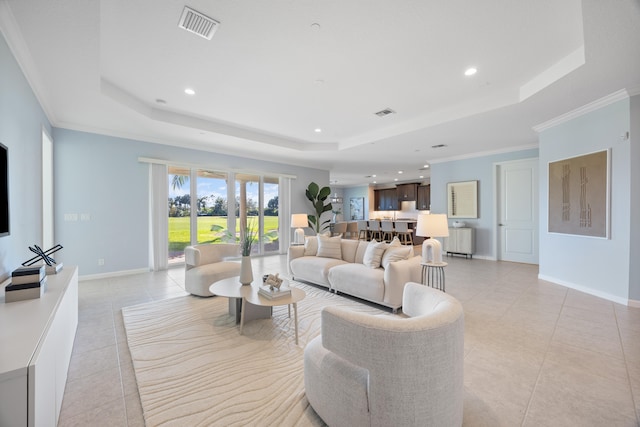 living room featuring a raised ceiling, light tile patterned floors, and ornamental molding