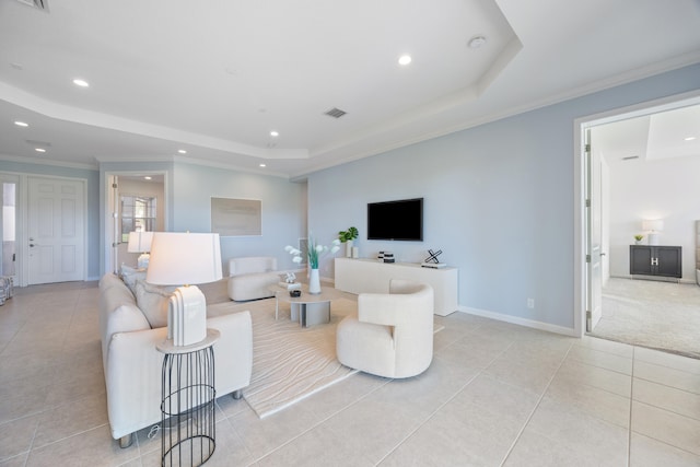 living room featuring light tile patterned flooring, ornamental molding, and a tray ceiling