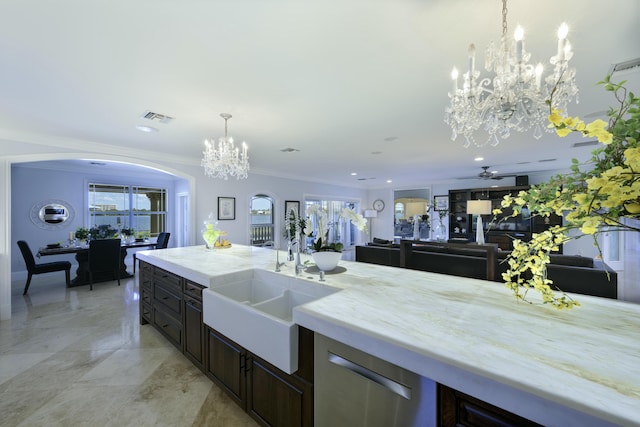 kitchen featuring sink, ceiling fan, a wealth of natural light, pendant lighting, and crown molding