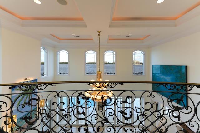 interior details with coffered ceiling, an inviting chandelier, ornamental molding, beamed ceiling, and a water view