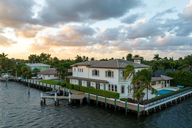 back house at dusk with a water view