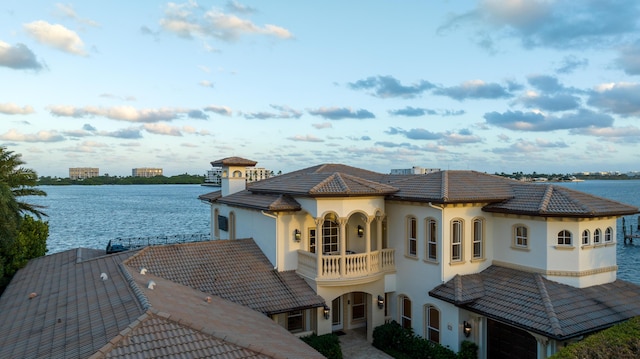 exterior space with a balcony and a water view